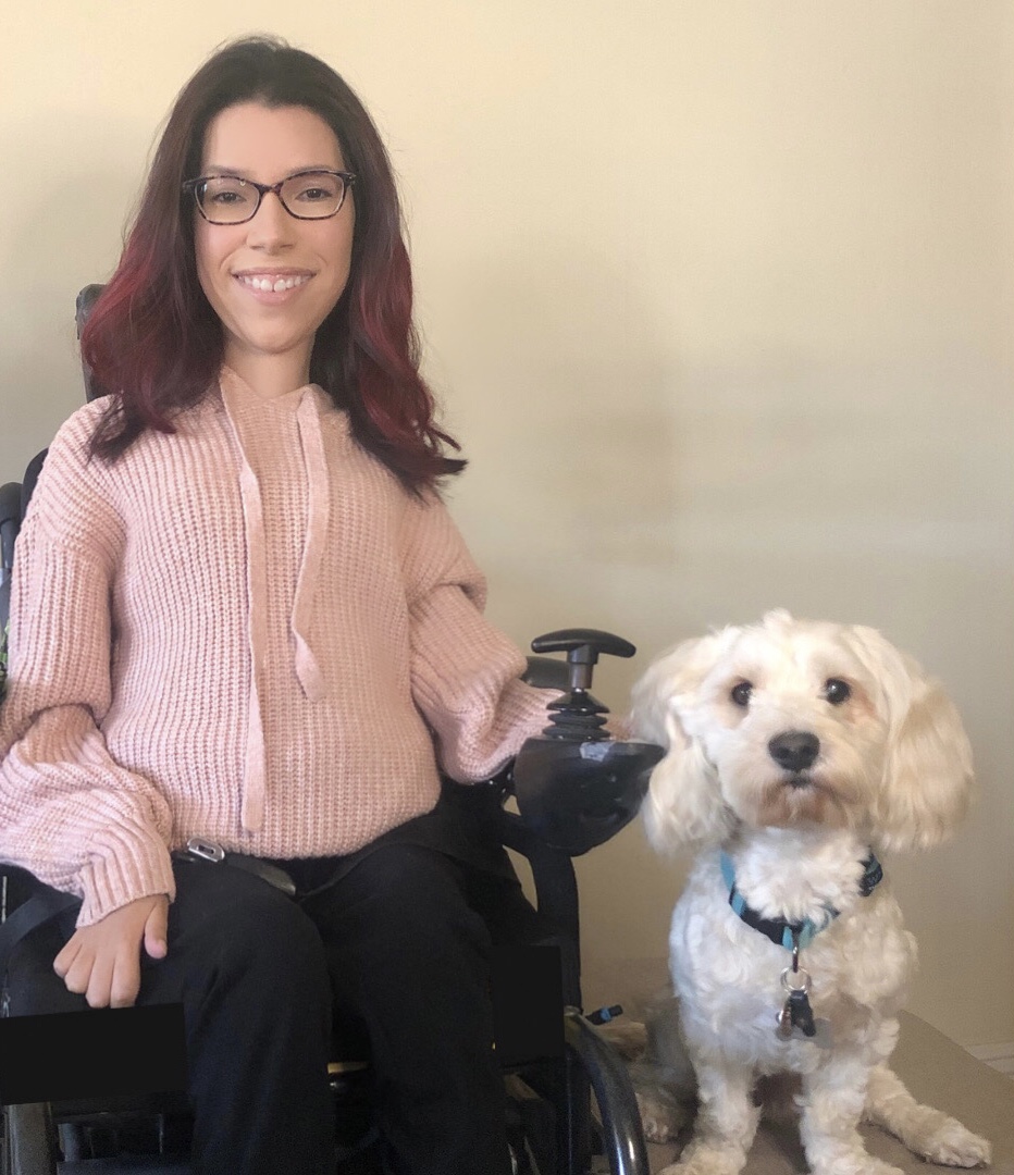 Sarah Rodriguez smiling facing camera with dog