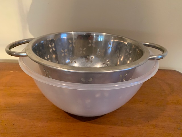 metal colander in bowl